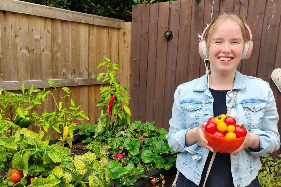 Learning gardening skills with Ways to Wellness programme in Oxfordshire A lady enjoying growing vegetables through Ways to Wellness programme in Oxfordshire