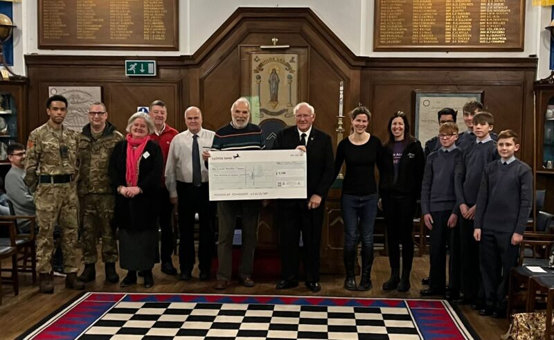 A group or charities at the Freemasons in Wallingford collecting a cheque