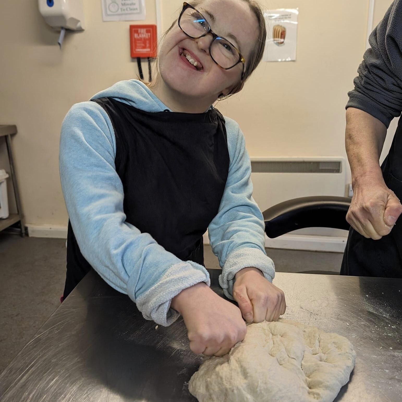 A lady enjoying making bread - Employment support in Oxfordshire, Style Acre