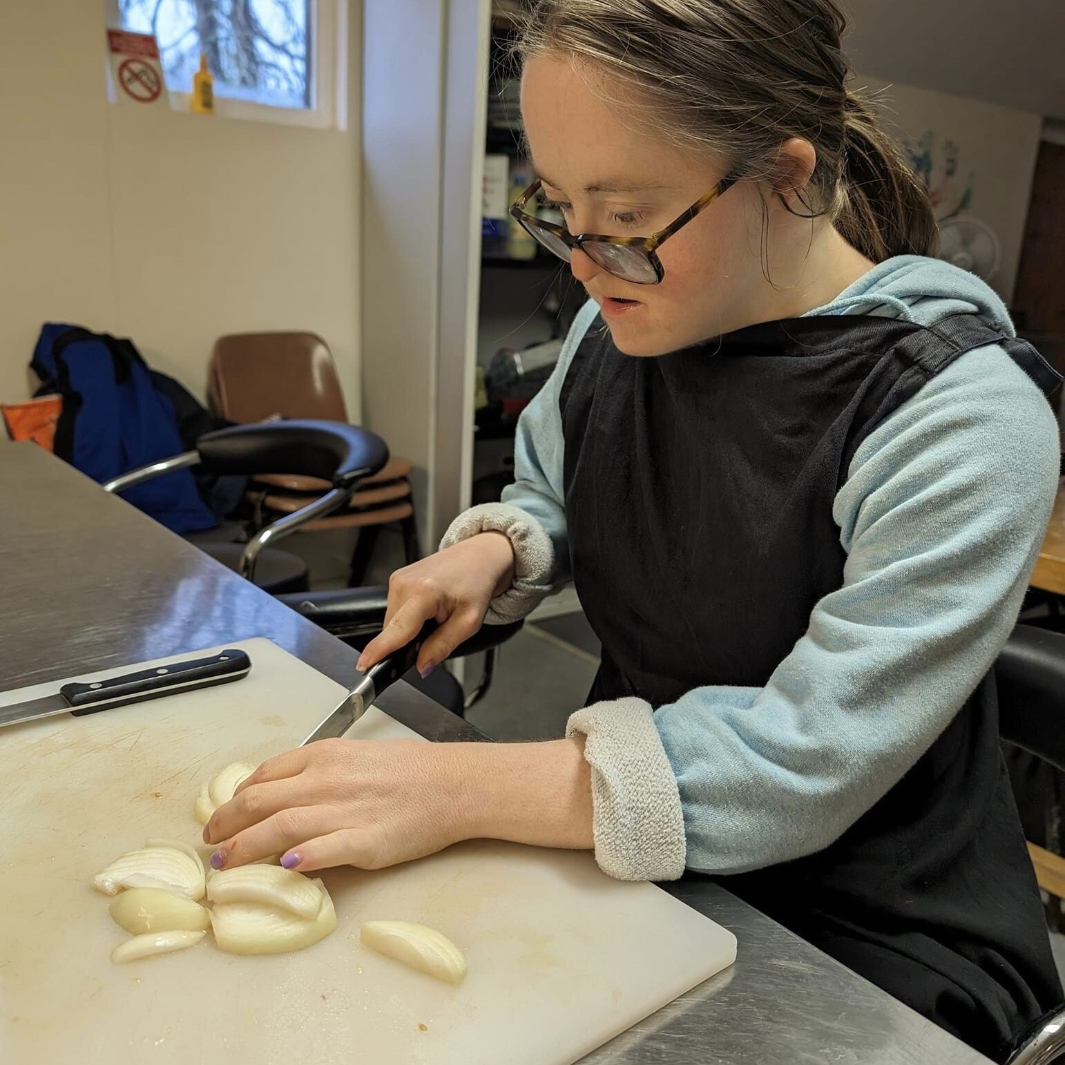 A lady enjoying learning new skills in the kitchen - Employment support in Oxfordshire, Style Acre