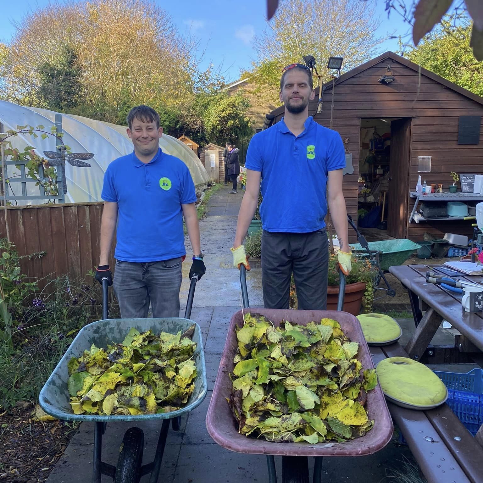 Two of the Green Acre team helping to clear leaves in wheelbarrows at Wantage Marketing Garden - Green Acre Garden Maintenance in Wallingford Didcot