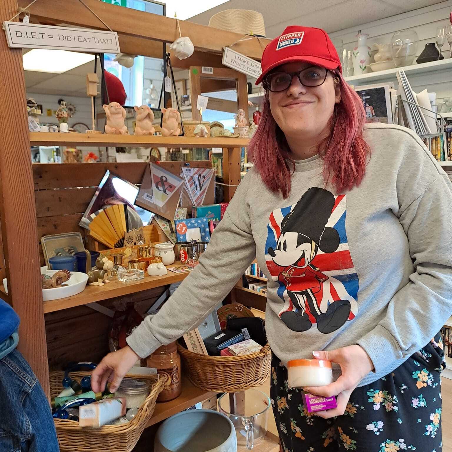 A lady sorting donated goods at the Charity Shop - Employment support in Oxfordshire, Style Acre