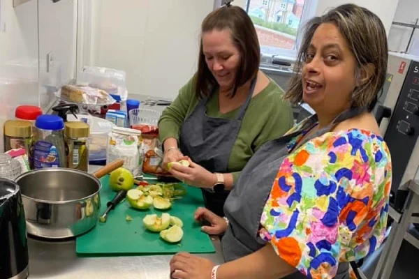 A person being supported to learn cooking skills