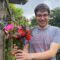 AA person volunteering at a garden holding flowers