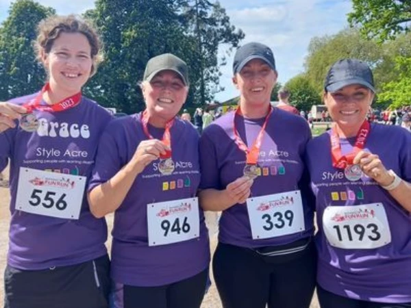 4 ladies showing their medals after running Blenheim 7K to raise money for Style Acre