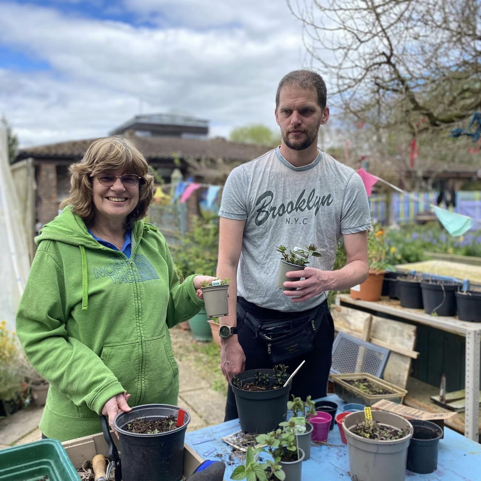 A lady and a gentleman enjoying learning gardening skills at Wantage Market Garden in Oxfordshire