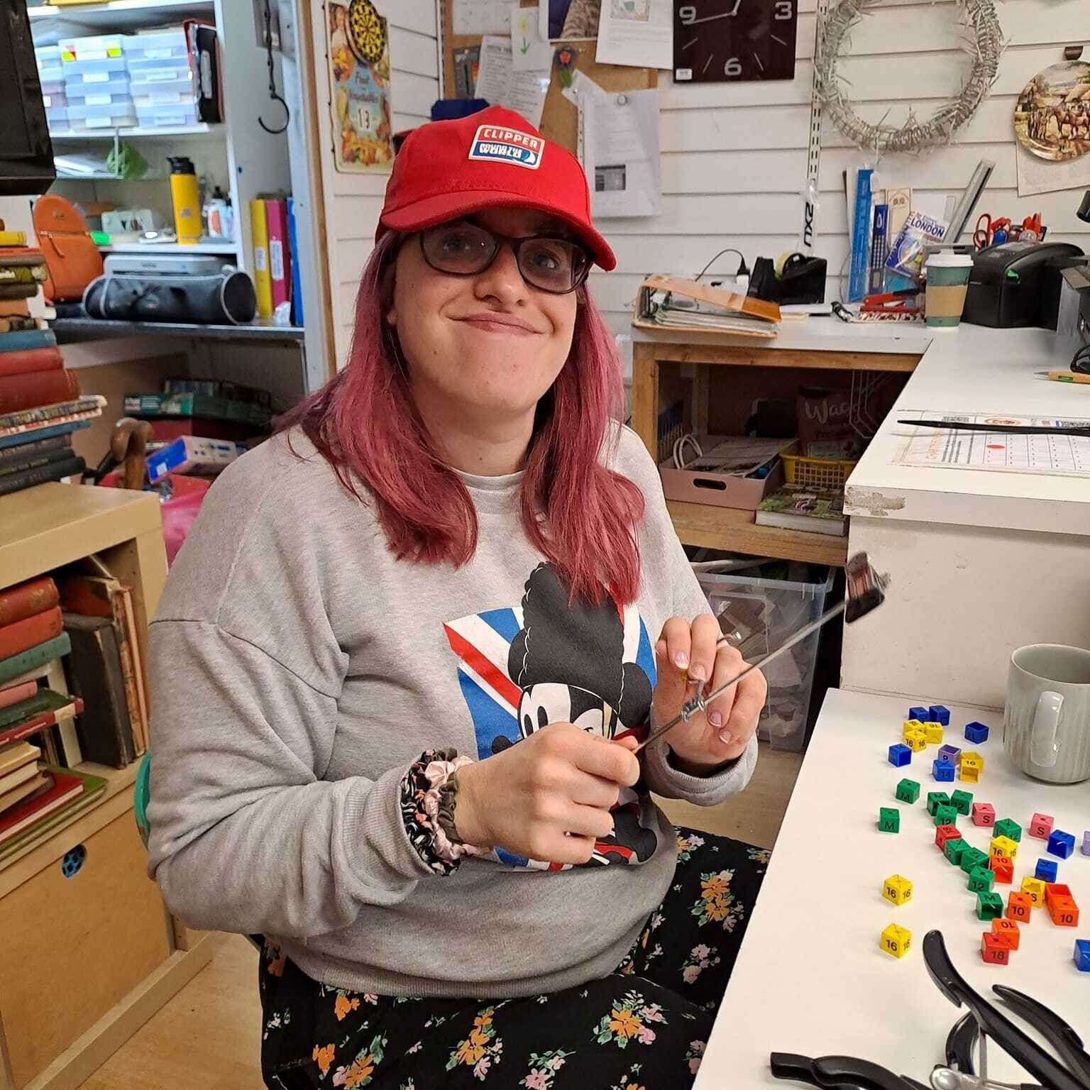 A lady sorting sizing cubes for coat hangers at the Style Acre Charity Shop