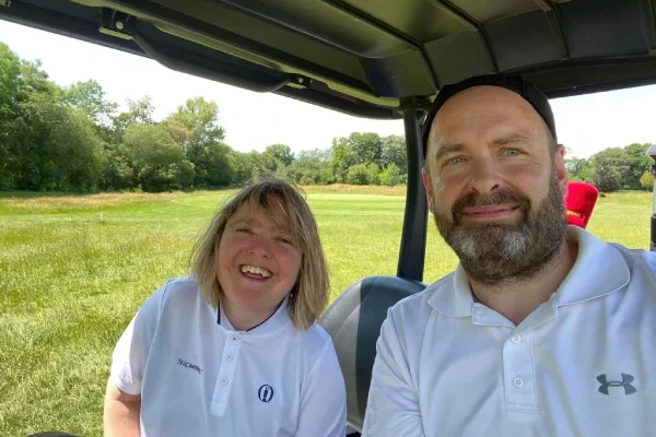 Two people in a golf buggy during a Style Acre Golf day