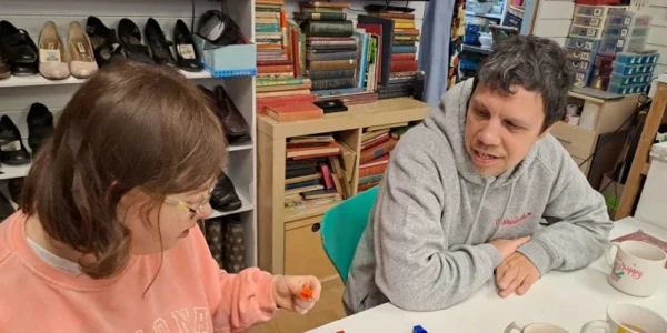 Two people we support working at the Style Acre shop - live your life