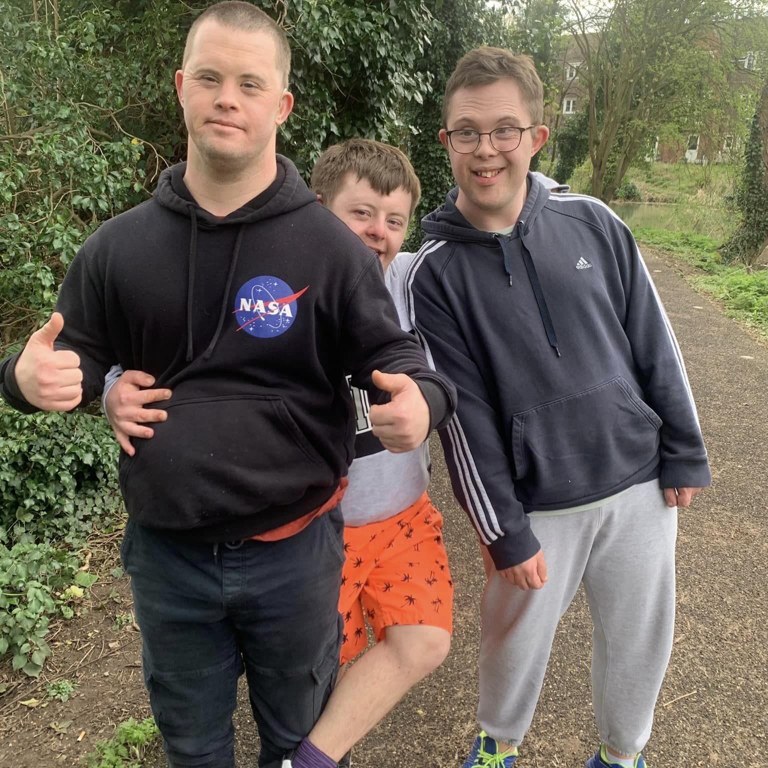 Friends on a walk, smiling at the camera