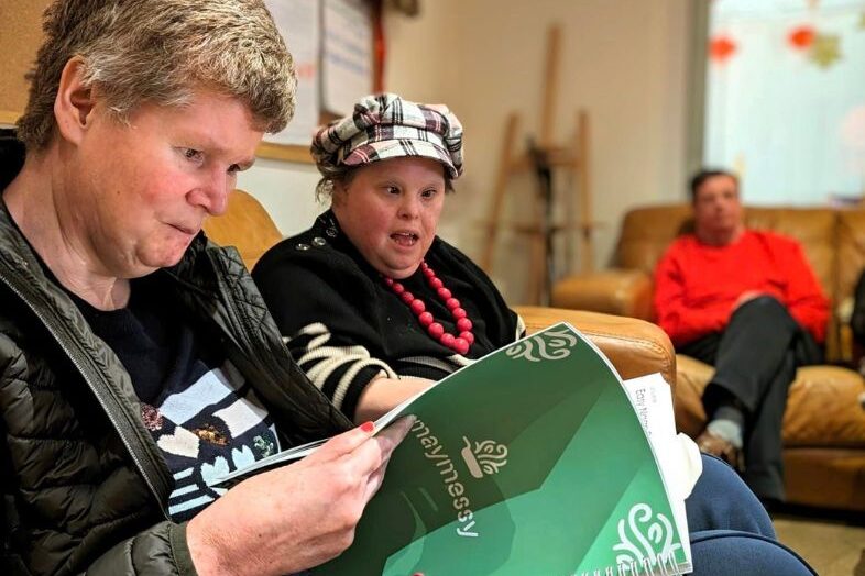 Two people looking through a book