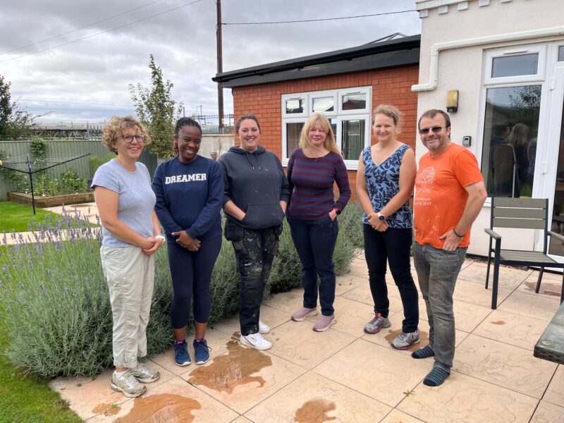 Five ladies and one gentleman standing together in a back garden ready to volunteer.