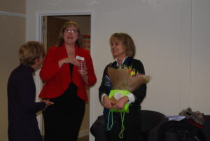Sinead Cusack being presented flowers at the opening of T2 community hub in 2012