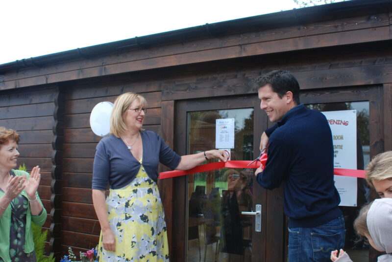 Tim Henman cutting a red ribbon to officially open the Tea Room