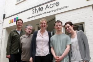 Staff and people supported by Style Acre standing outside the SABre building