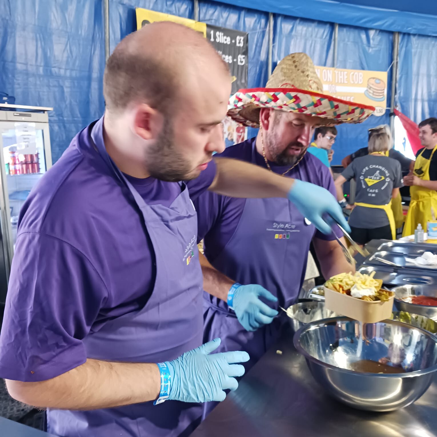 two Style Acre volunteers serving Chilli and Nachos at Truck Festival