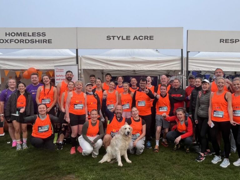 Team 2025 Team of 50 runners in bright orange running vests.