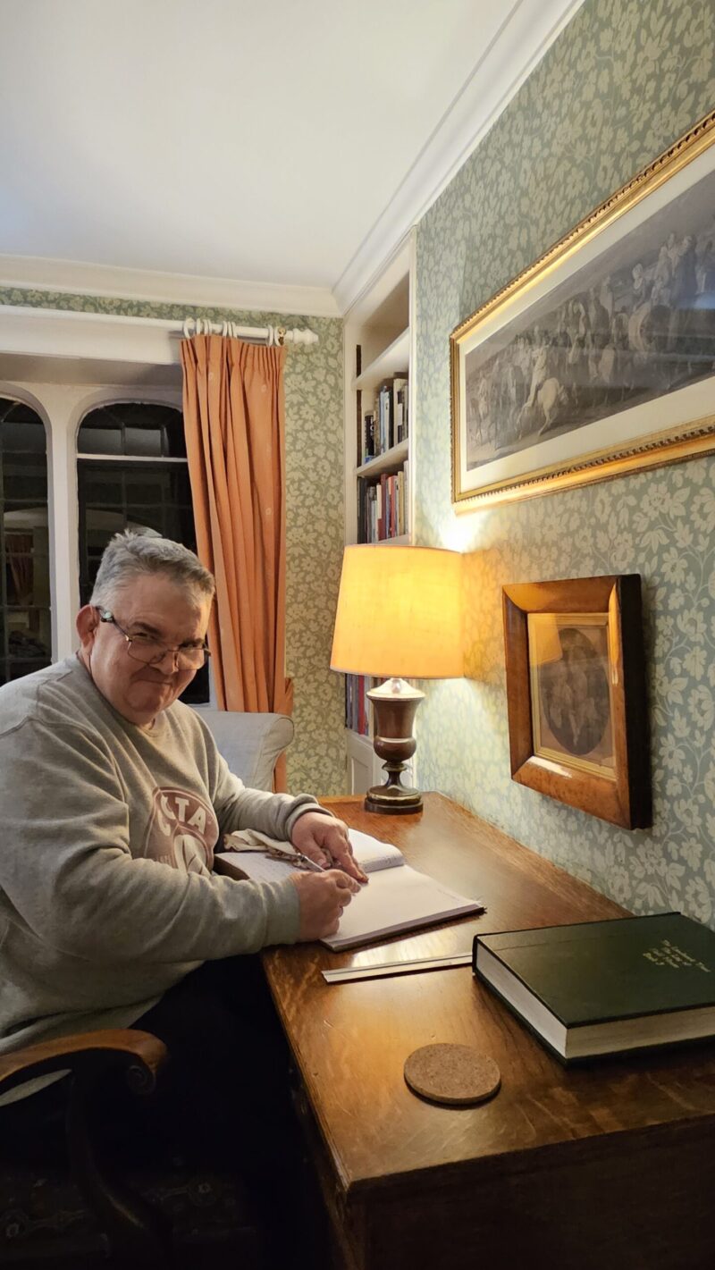 Writing a letter at a writing desk in an old farmhouse