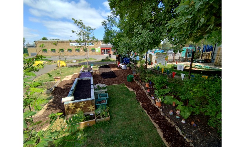 Picture of the garden at the Berin Centre with a path and raised beds.