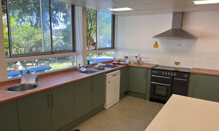 Newly fitted green kitchen units at Turnstyle community hub