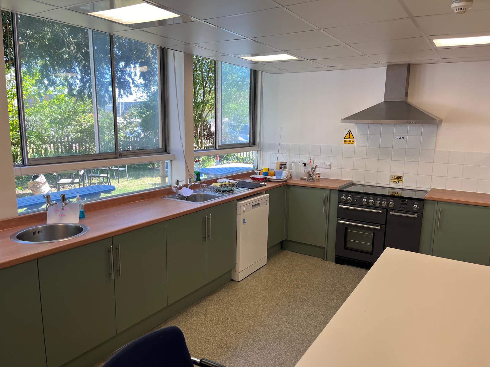 Newly fitted green kitchen units at Turnstyle community hub