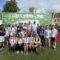 A group of 22 men and women stanging infront of a Cotswold Way Ultra Challenge Sign.