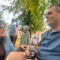 Two people chatting under trees at a picnic