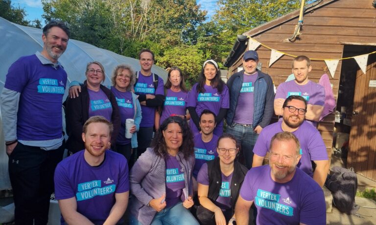 Vertex Team 2026 A group photo of 14 people from Vertex standing and kneeling in the wantage market garden