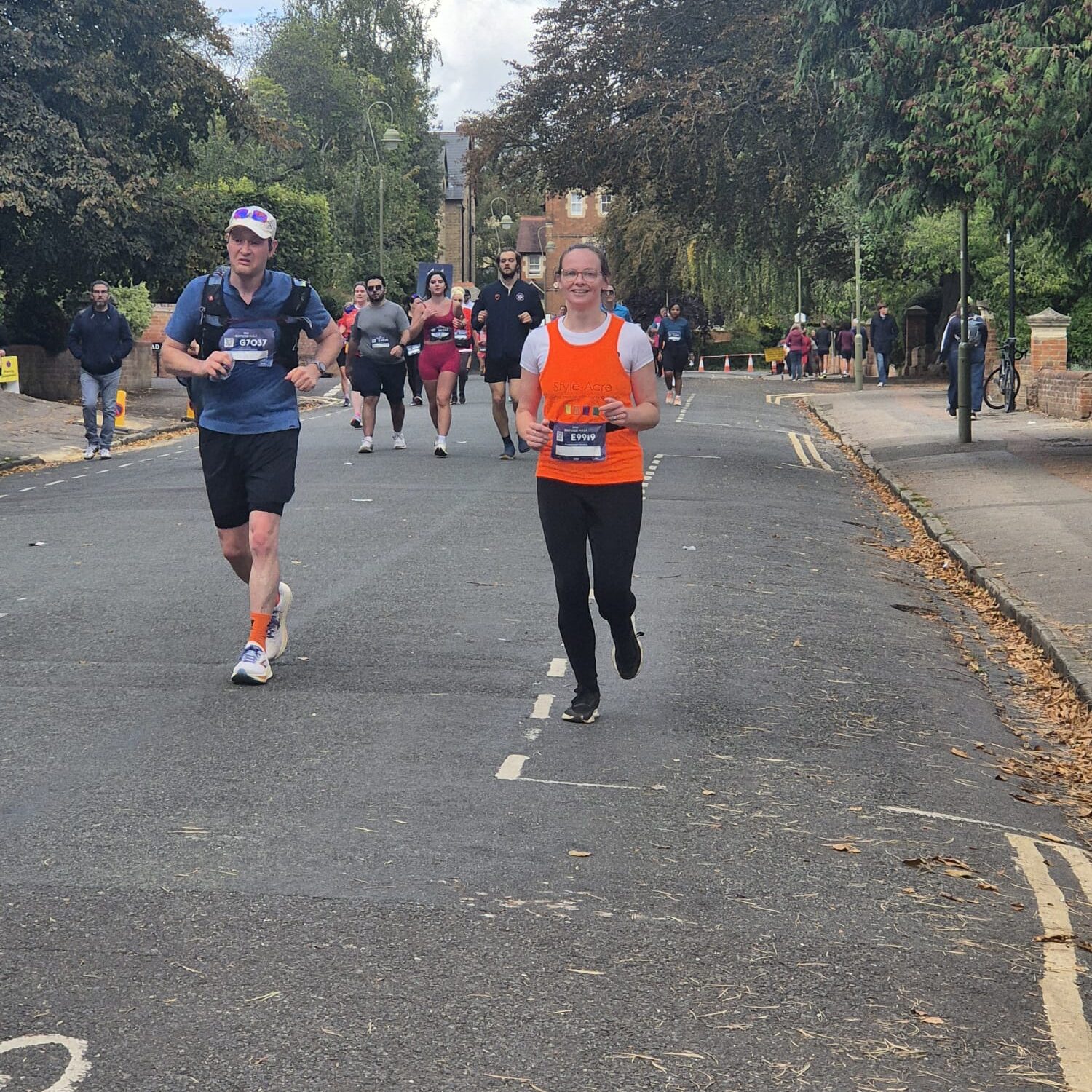 Lady running the Oxford Half in an orange vest