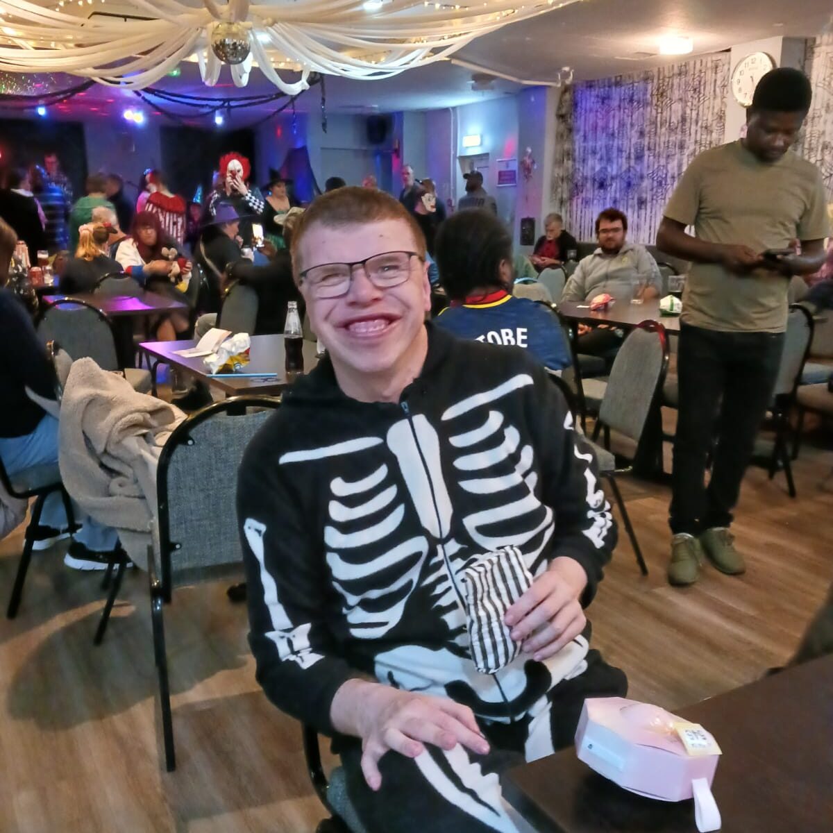 A man sat in a skeleton onesie